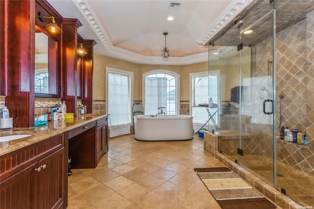 bathroom with vanity, plus walk in shower, crown molding, tile walls, and a tray ceiling