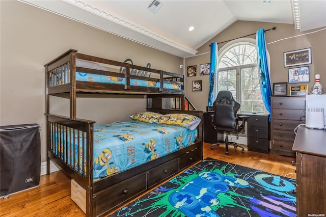 bedroom with hardwood / wood-style floors and vaulted ceiling