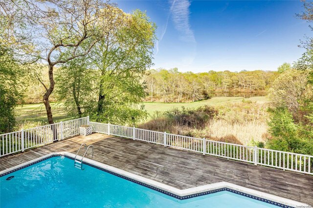 4 Irene Ln, Shelter Island, NY 11964 - swimming pool featuring a deck and a view of trees
