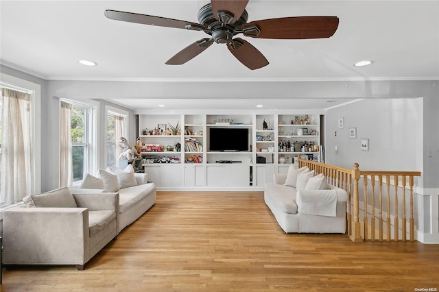 living room with ceiling fan, light hardwood / wood-style floors, and ornamental molding