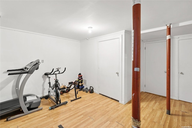 workout room with hardwood / wood-style floors