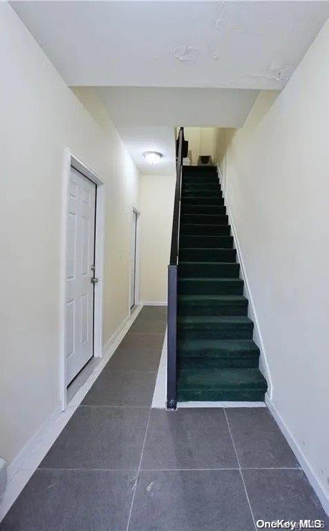 stairs with tile patterned floors