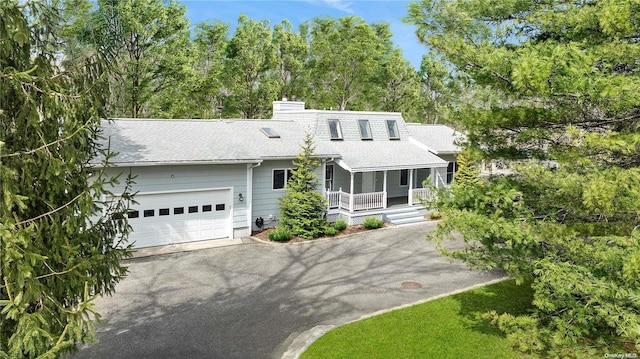 view of front of home with a porch and a garage