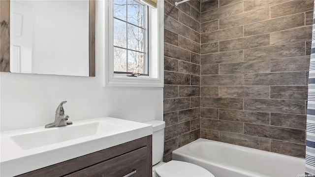 full bathroom with vanity, shower / bath combo, and toilet