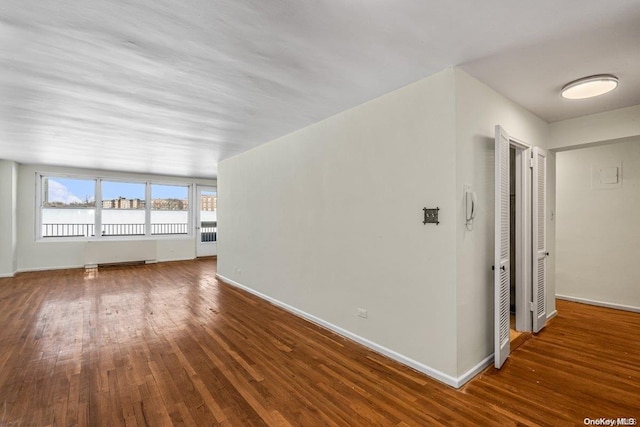 unfurnished living room featuring dark wood-type flooring