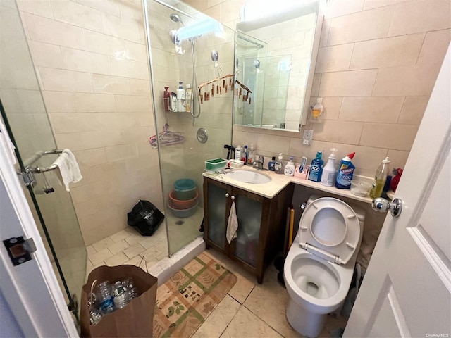 bathroom with vanity, tile patterned flooring, tiled shower, tile walls, and tasteful backsplash