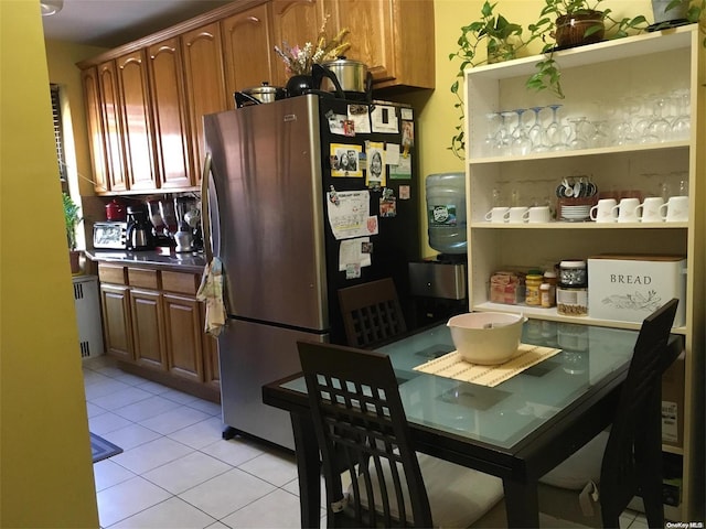 dining room with light tile patterned floors and radiator heating unit