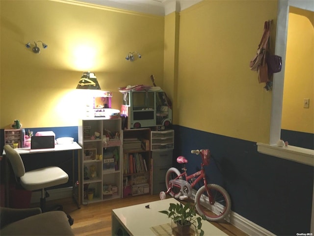 office area featuring wood-type flooring and crown molding