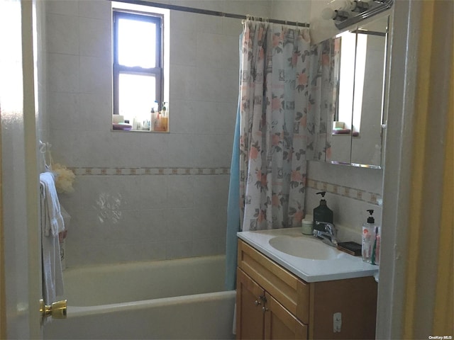 bathroom featuring vanity and shower / bath combo