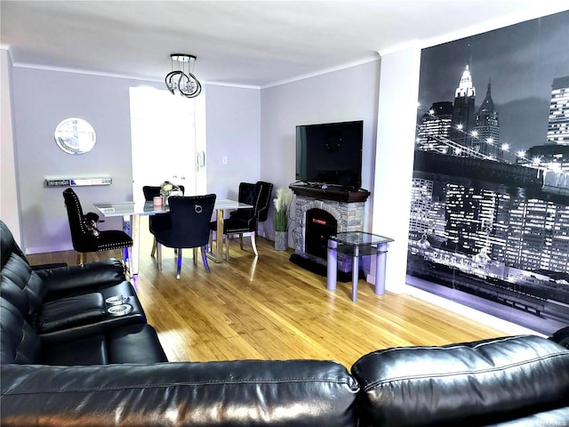 living room featuring a fireplace, hardwood / wood-style floors, and a notable chandelier