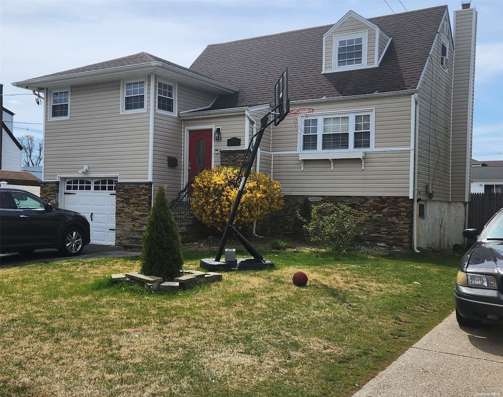 view of front of home with a garage and a front yard