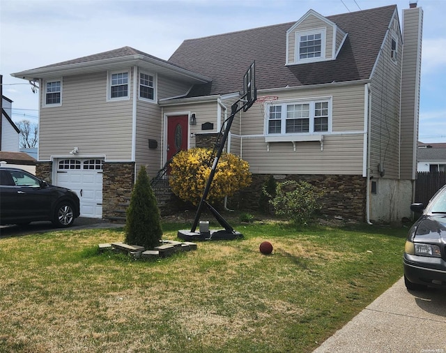 view of front of home with a garage and a front yard