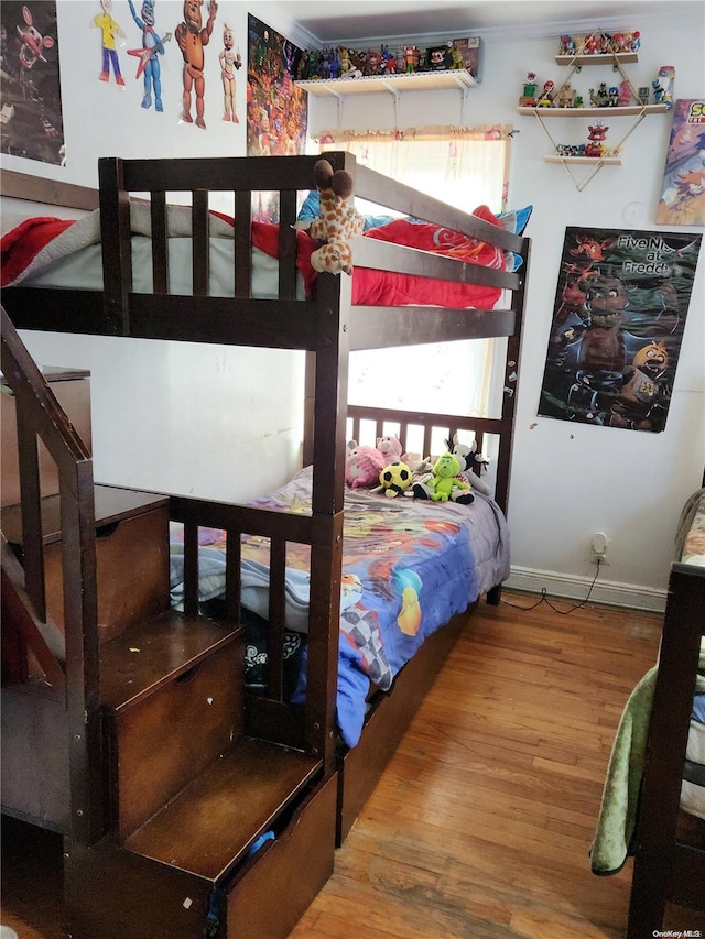 bedroom with hardwood / wood-style flooring