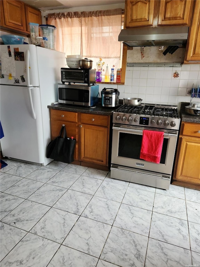 kitchen featuring appliances with stainless steel finishes and tasteful backsplash