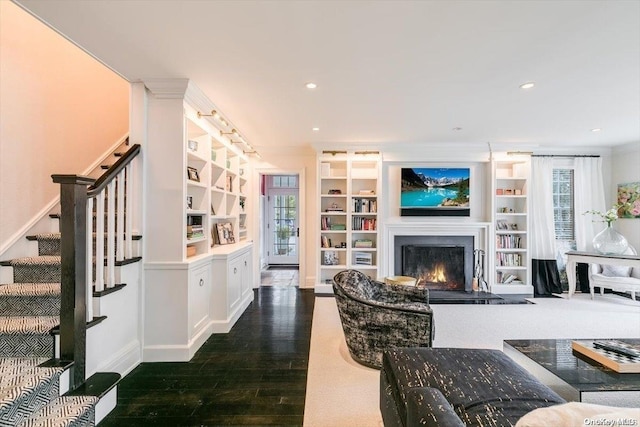 living room featuring ornamental molding, dark wood-type flooring, and a wealth of natural light