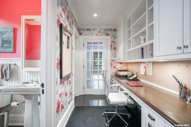 office area featuring sink, built in desk, and ornamental molding