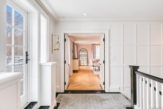 corridor featuring parquet flooring and ornamental molding