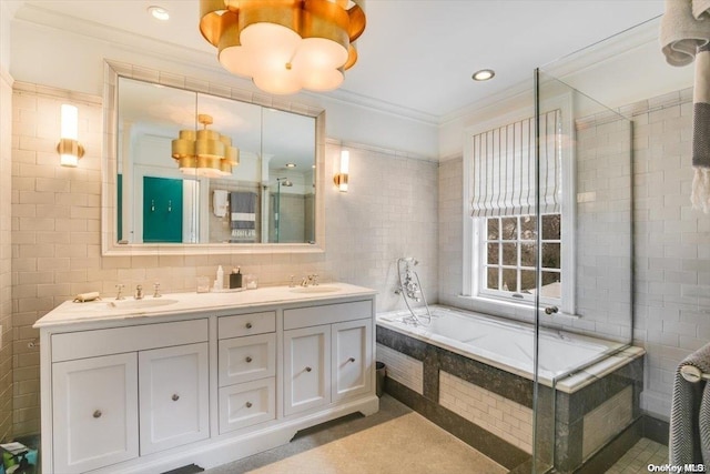 bathroom with ornamental molding, tile walls, and tiled bath