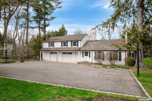 view of front property with a front yard and a garage