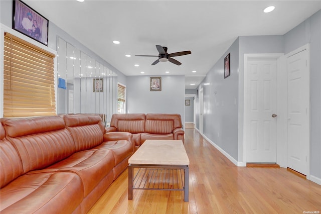 living room featuring ceiling fan and light hardwood / wood-style flooring