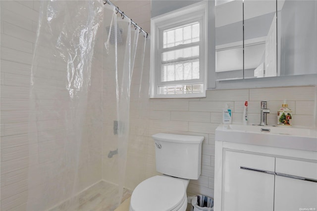 bathroom with vanity, toilet, tile walls, and curtained shower