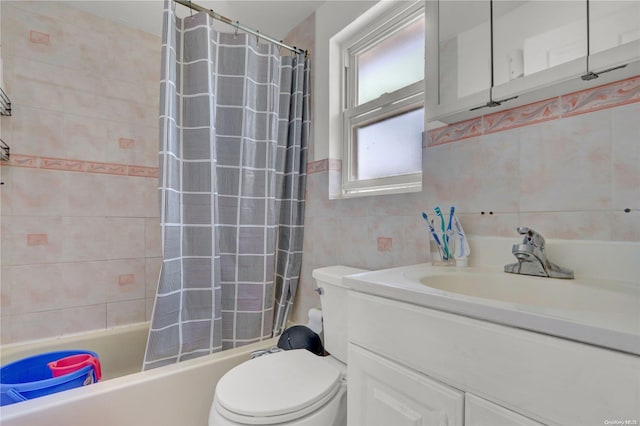 full bathroom with vanity, toilet, shower / bathtub combination with curtain, and tile walls