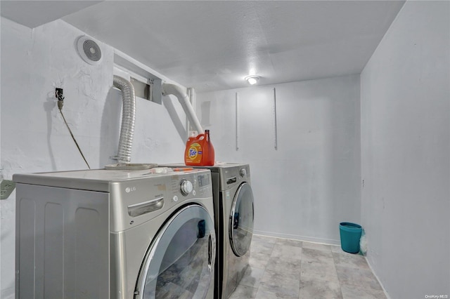 clothes washing area featuring washer and clothes dryer