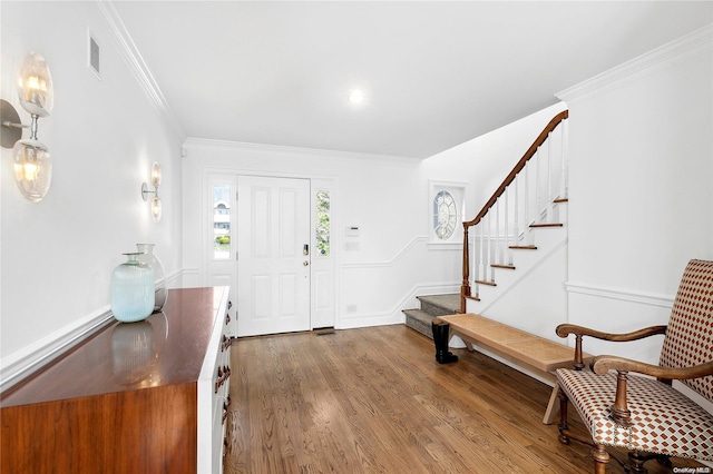 foyer entrance featuring hardwood / wood-style floors and ornamental molding