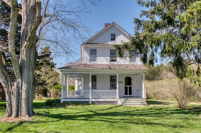 12115 Main Rd, East Marion, NY 11939 - view of front of property with covered porch, a chimney, and a front yard