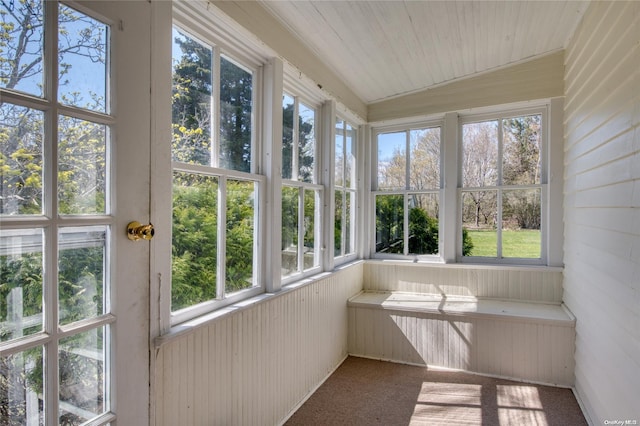 12115 Main Rd, East Marion, NY 11939 - unfurnished sunroom with plenty of natural light, carpet floors, and wood walls