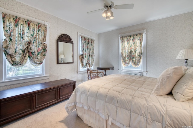 bedroom with ceiling fan and light colored carpet