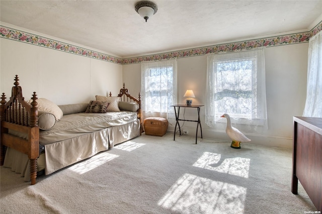 bedroom featuring a textured ceiling and light colored carpet