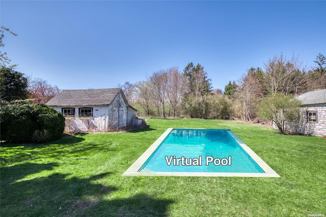 view of pool with a lawn and an outbuilding