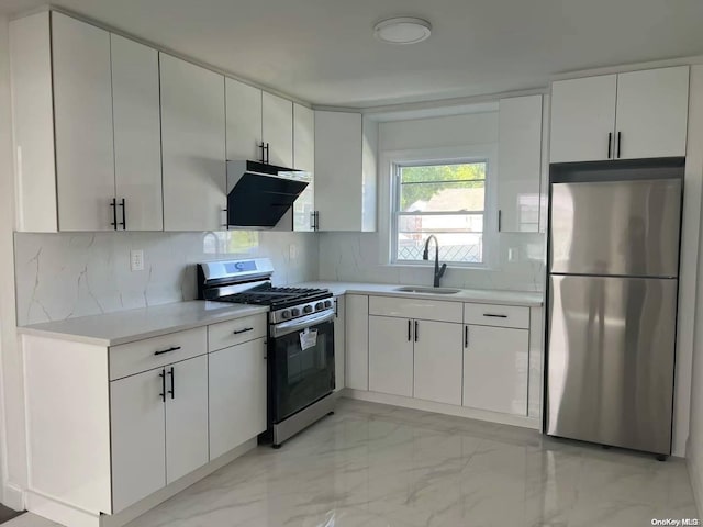 kitchen featuring appliances with stainless steel finishes, tasteful backsplash, white cabinetry, and sink