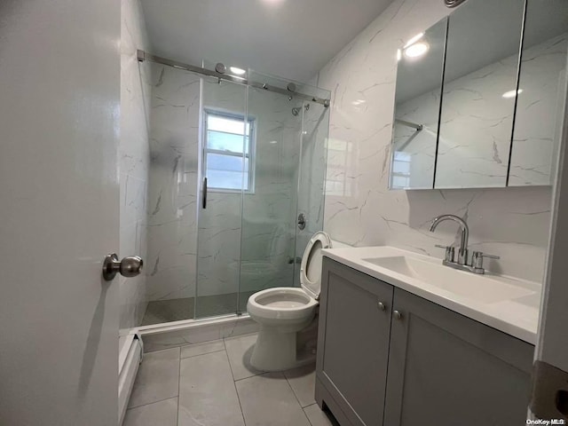 bathroom featuring toilet, vanity, a shower with shower door, and a baseboard heating unit