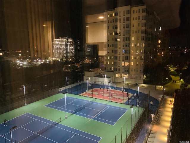 view of tennis court featuring basketball hoop