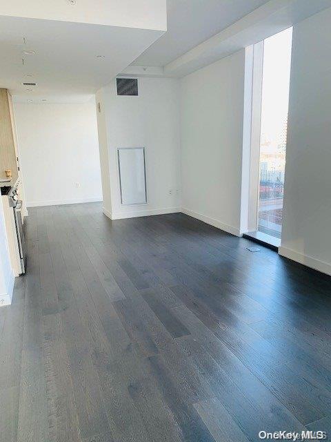 empty room with dark wood-type flooring