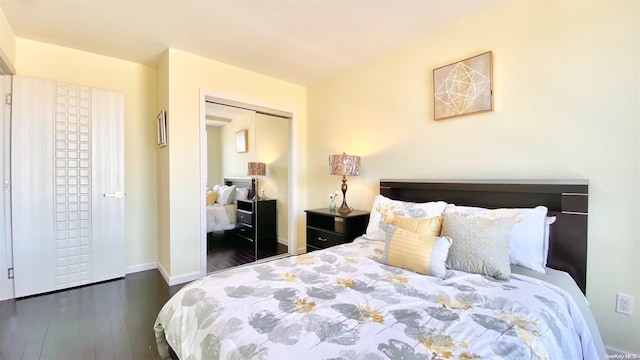 bedroom with dark hardwood / wood-style flooring and a closet