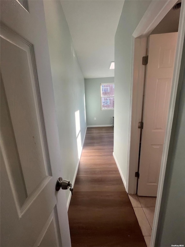 corridor with wood-type flooring