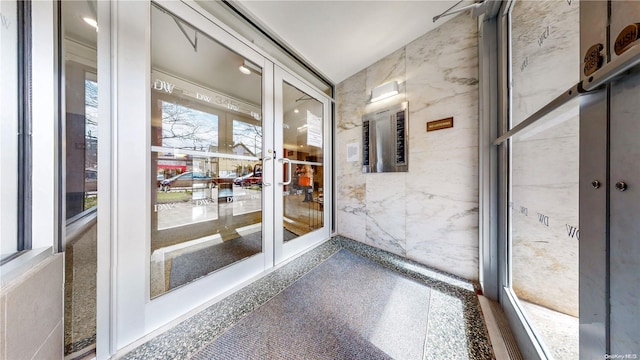 unfurnished sunroom with lofted ceiling