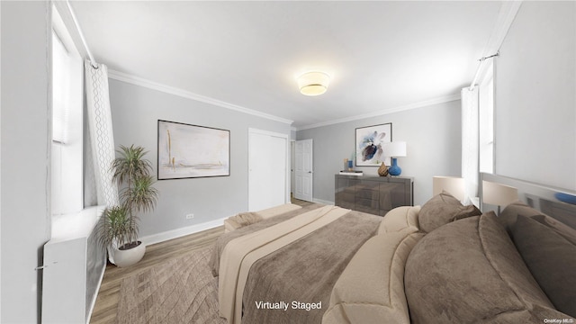 bedroom featuring light hardwood / wood-style flooring and ornamental molding