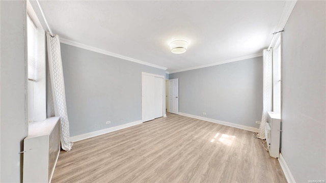 interior space with crown molding and light hardwood / wood-style flooring