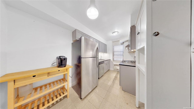 kitchen with gray cabinetry, decorative backsplash, and appliances with stainless steel finishes