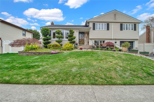 tri-level home featuring a front lawn