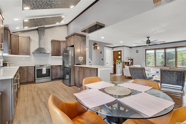 dining room with ceiling fan, light hardwood / wood-style flooring, ornamental molding, and sink