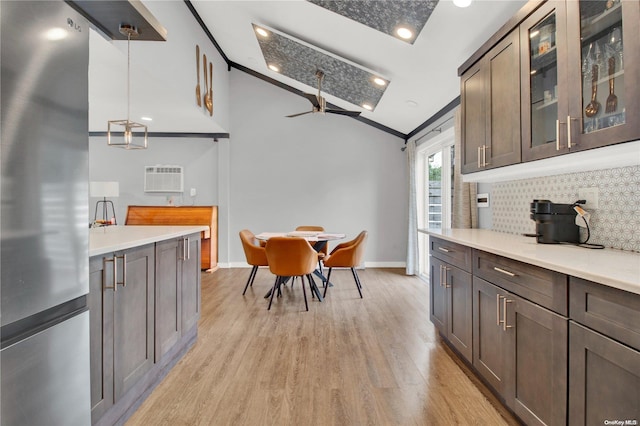 kitchen with ceiling fan, light hardwood / wood-style flooring, decorative light fixtures, dark brown cabinets, and ornamental molding