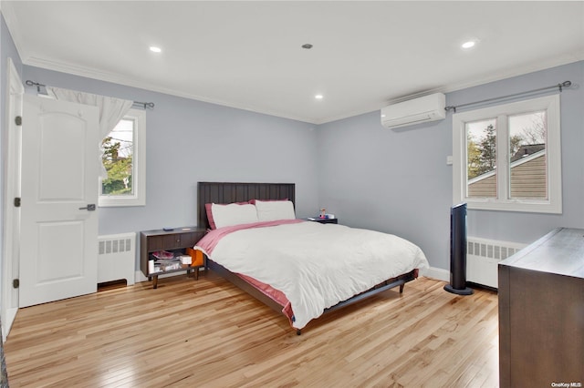 bedroom featuring multiple windows, light wood-type flooring, a wall unit AC, and radiator