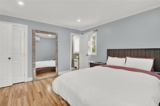 bedroom with radiator heating unit, light hardwood / wood-style floors, a closet, and crown molding