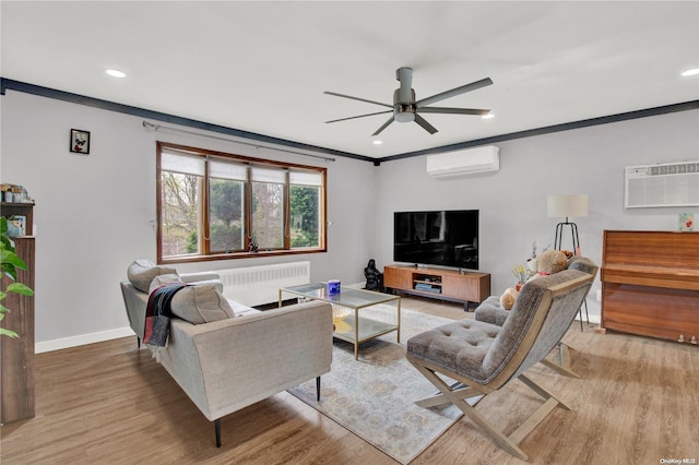 living room featuring ceiling fan, light hardwood / wood-style floors, radiator heating unit, and a wall unit AC