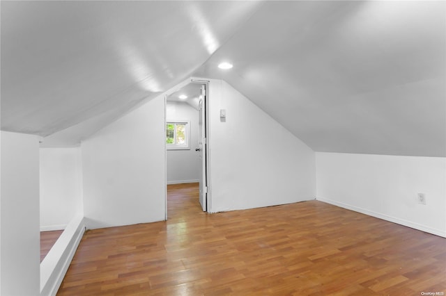 bonus room with hardwood / wood-style flooring and lofted ceiling